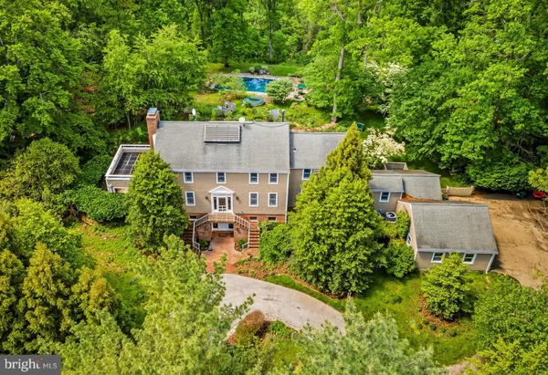 an aerial view of a house with a yard basket ball court and outdoor seating