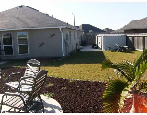 a view of a house with backyard tub and sitting area