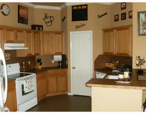 a kitchen with stainless steel appliances granite countertop a stove and a refrigerator