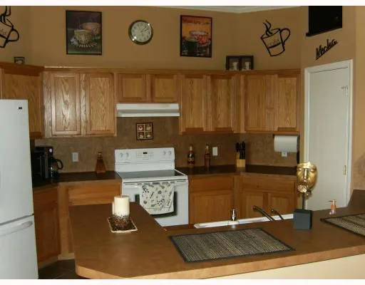 a kitchen with a refrigerator and cabinets