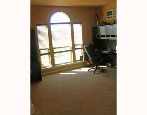 a view of a livingroom with workspace and a window