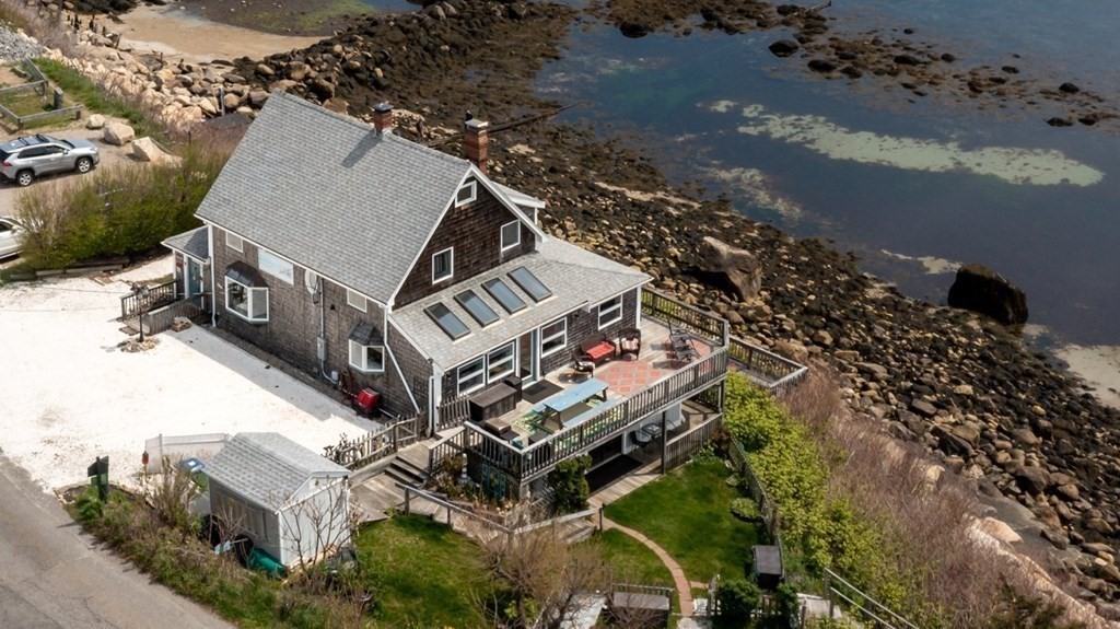 an aerial view of a house with a yard