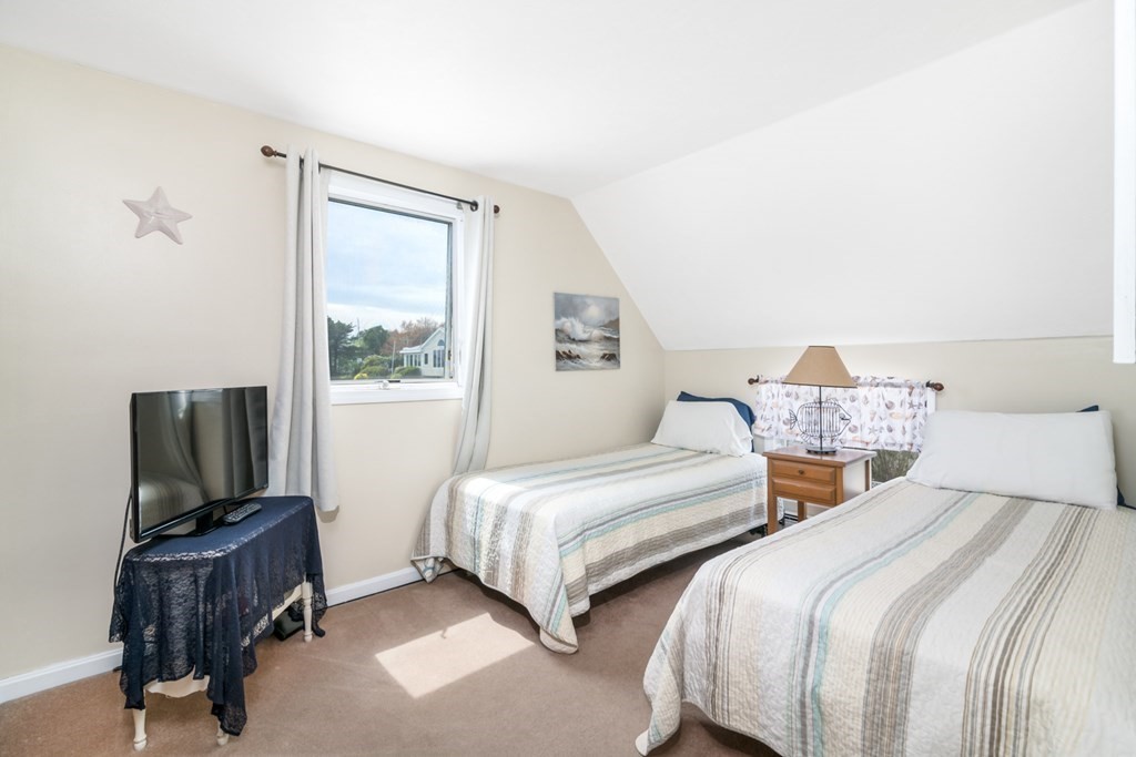 262 Manomet Point Road Plymouth, MA 02360 - Photo 19 of 40 a bedroom with two beds and a flat screen tv