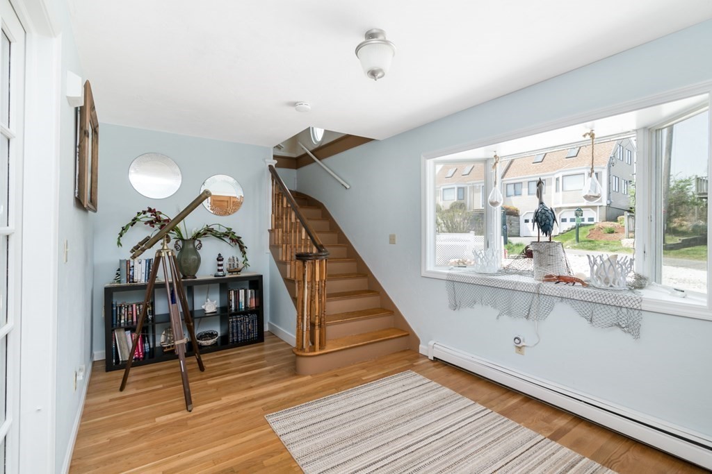 262 Manomet Point Road Plymouth, MA 02360 - Photo 26 of 40 a view of a hallway with wooden floor and staircase