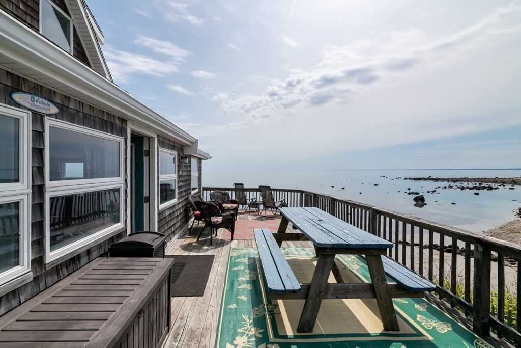 262 Manomet Point Road Plymouth, MA 02360 - Photo 29 of 40 a view of a balcony with two chairs and a barbeque