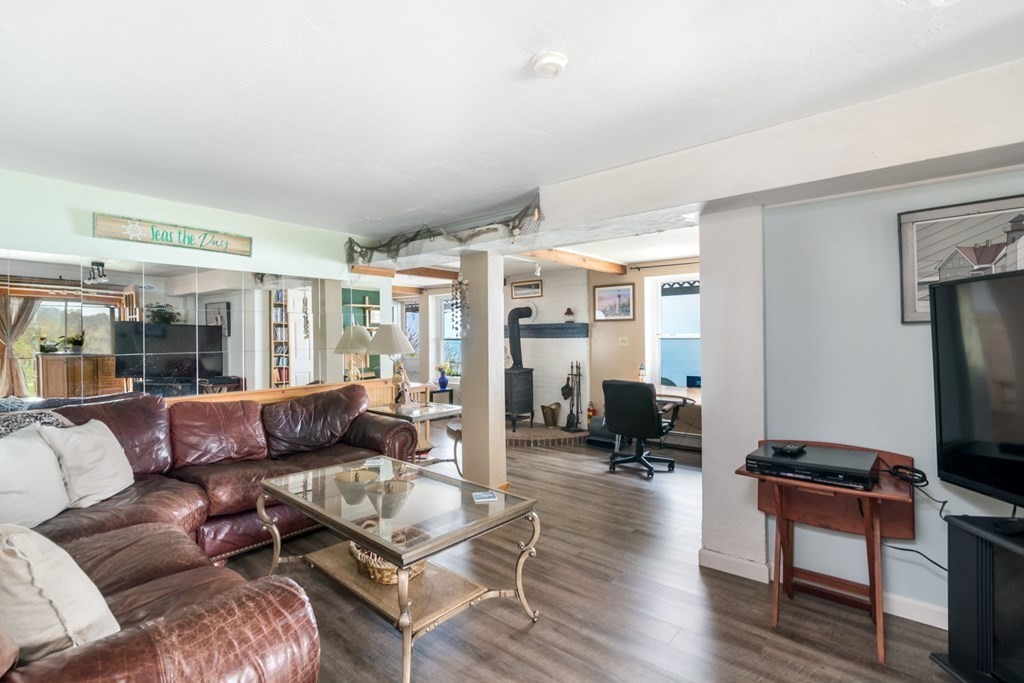 262 Manomet Point Road Plymouth, MA 02360 - Photo 9 of 40 a living room with furniture gym equipment and a large window