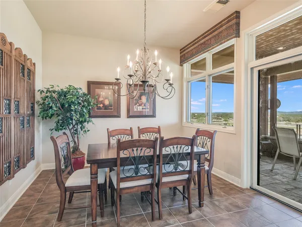 a view of a dining room with furniture and chandelier