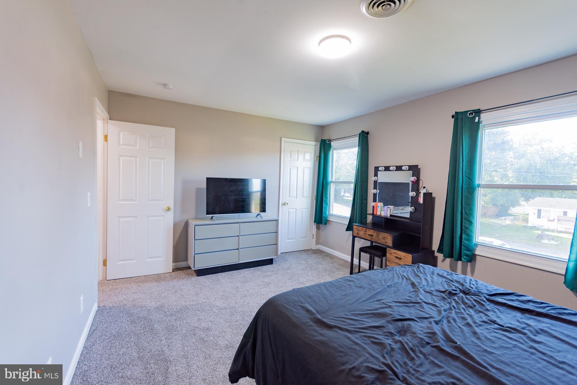 306 East 12th Avenue, Unit B Ranson, WV 25438 - Photo 17 of 31 a bedroom with a bed and furniture