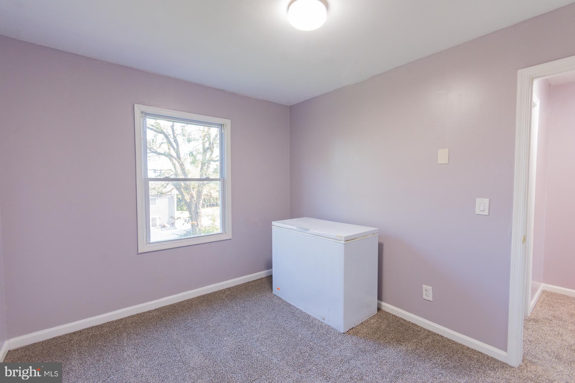 306 East 12th Avenue, Unit B Ranson, WV 25438 - Photo 20 of 31 an empty room with windows and closet