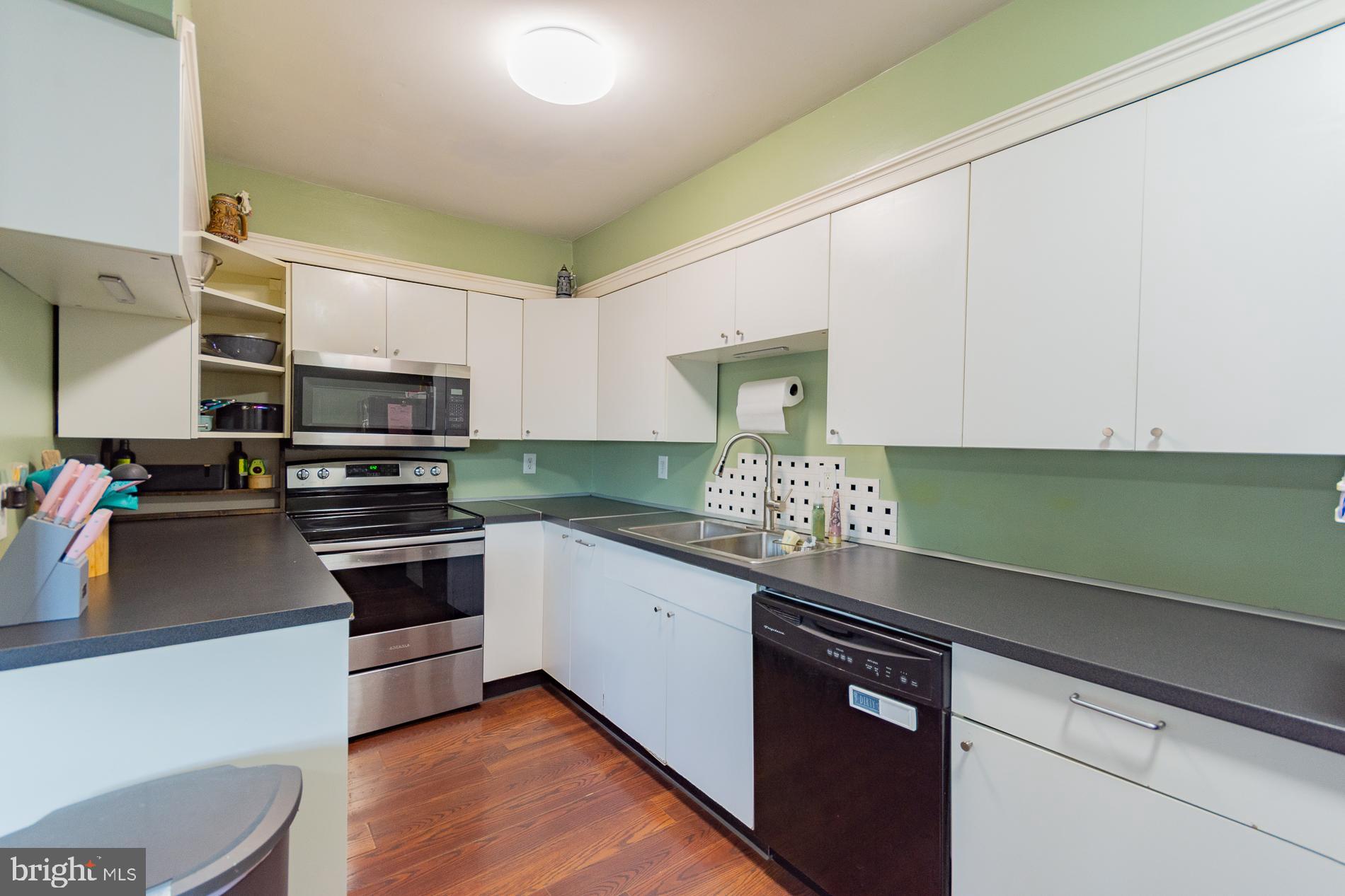306 East 12th Avenue, Unit B Ranson, WV 25438 - Photo 10 of 31 a kitchen with granite countertop stainless steel appliances and white cabinets