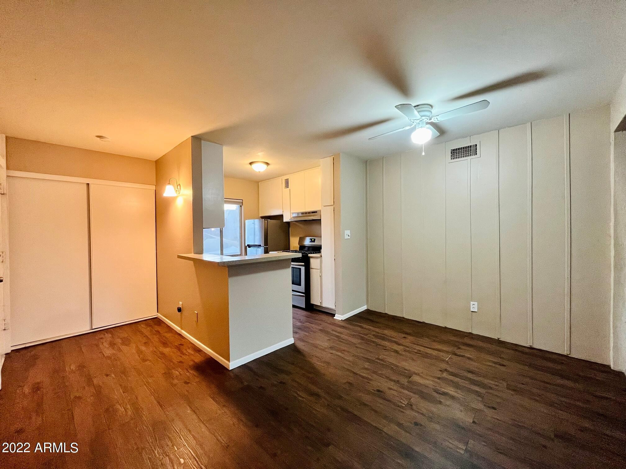 1701 West Tuckey Lane, Unit 225 Phoenix, AZ 85015 - Photo 10 of 13 a view of kitchen with wooden floor and electronic appliances