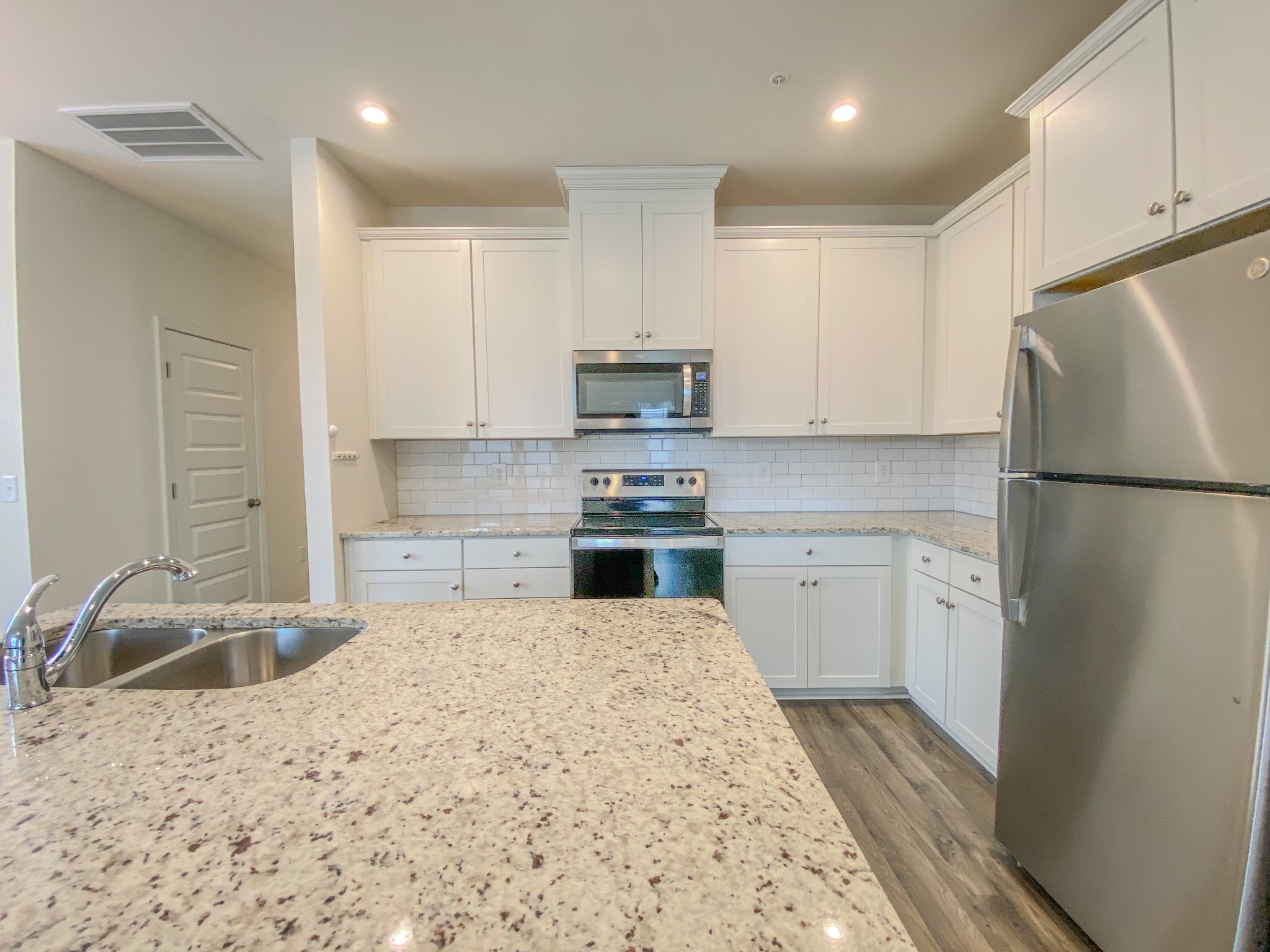3315 Deerchase Circle Murfreesboro, TN 37129 - Photo 6 of 37 a kitchen with granite countertop a refrigerator sink stove and white cabinets