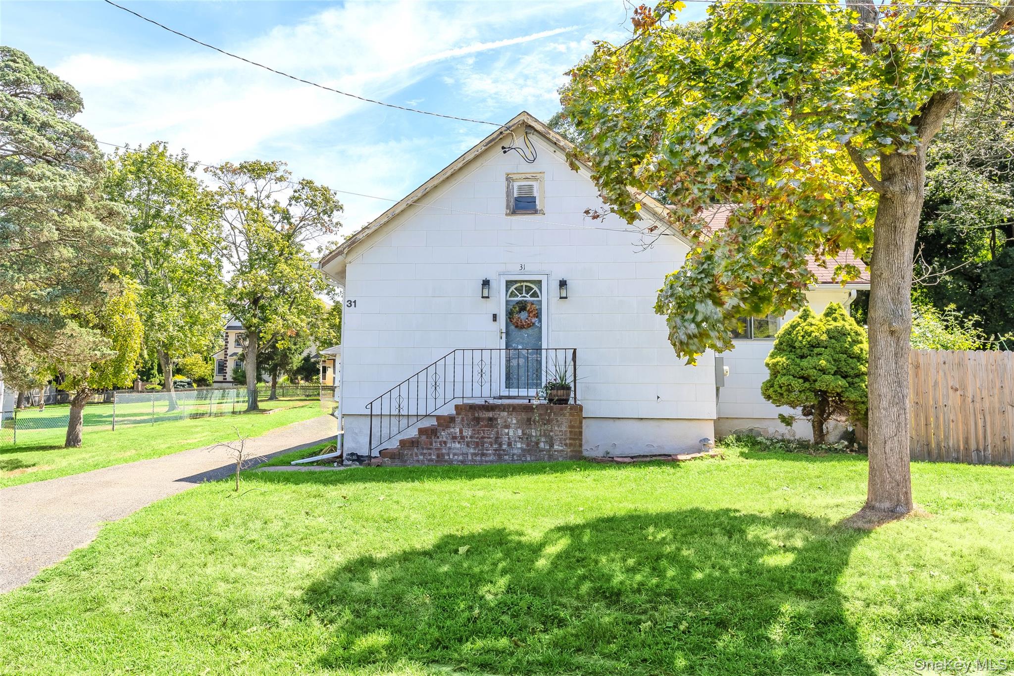 a view of a house with a yard and tree s