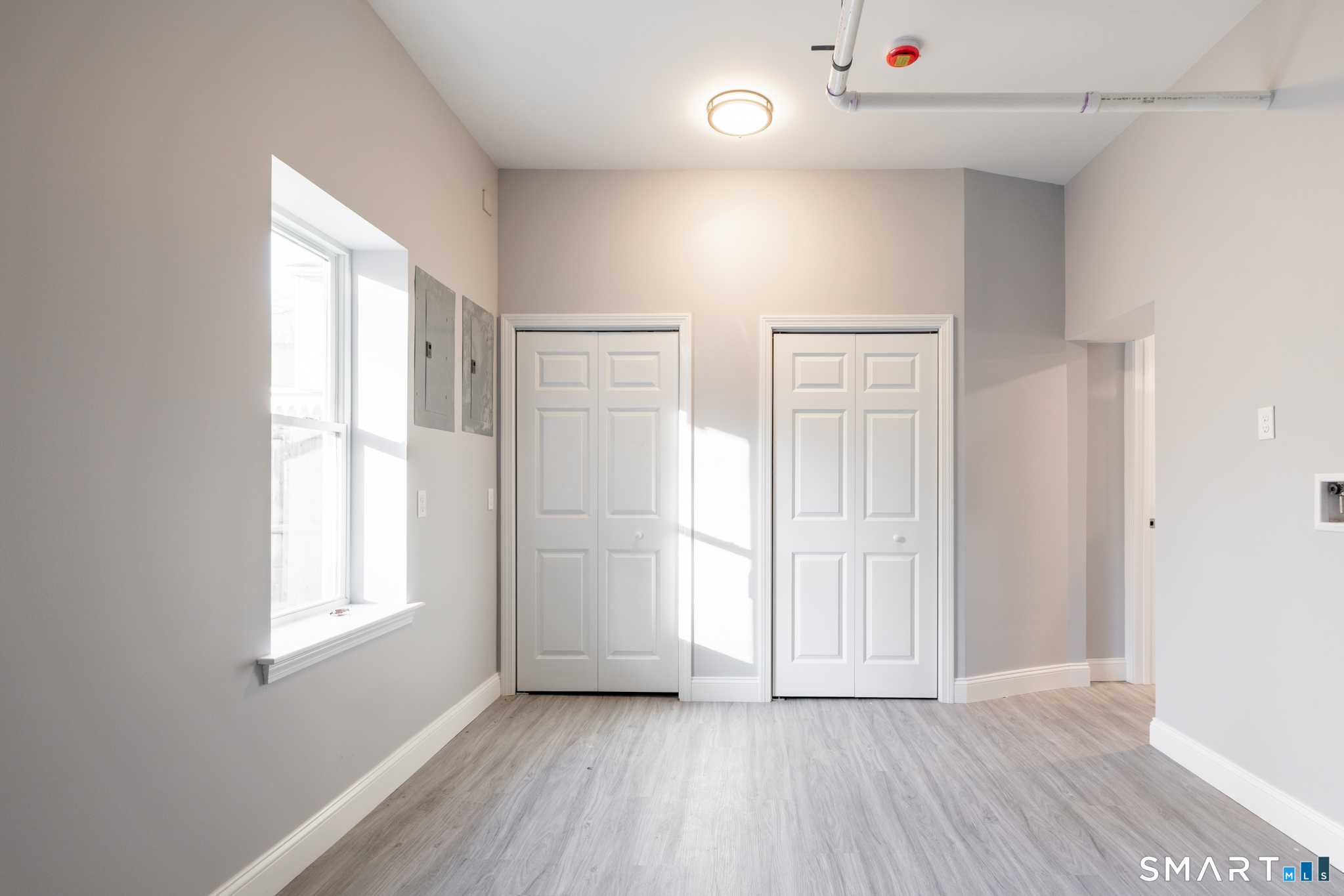 159 Park Street Bristol, CT 06010 - Photo 11 of 39 an empty room with wooden floor and windows