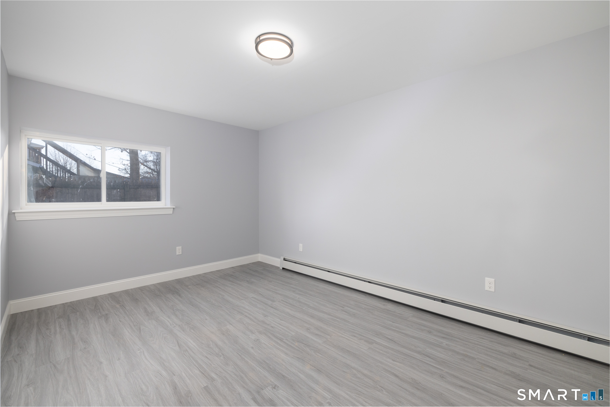 159 Park Street Bristol, CT 06010 - Photo 14 of 39 an empty room with wooden floor and windows