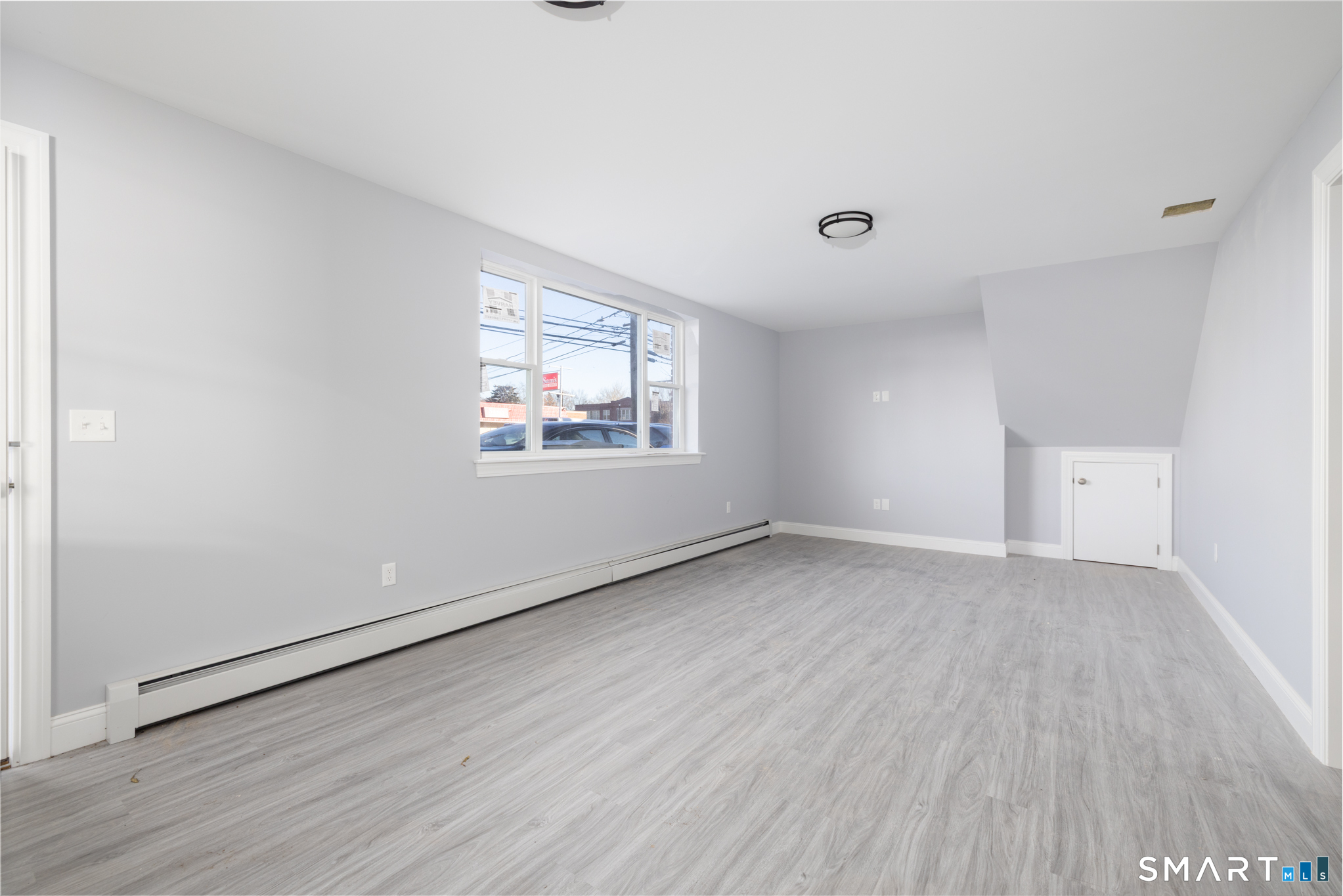 159 Park Street Bristol, CT 06010 - Photo 3 of 39 an empty room with wooden floor and windows