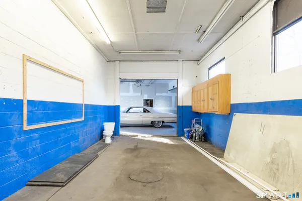 a view of a car garage with a car parked in it