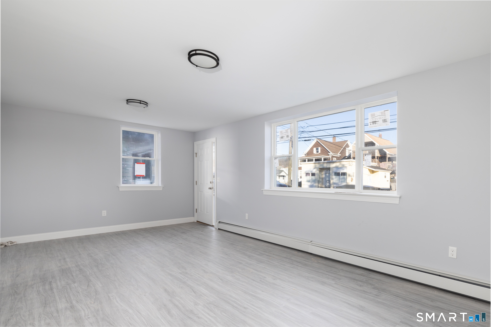 159 Park Street Bristol, CT 06010 - Photo 5 of 39 a view of an empty room with wooden floor and a window