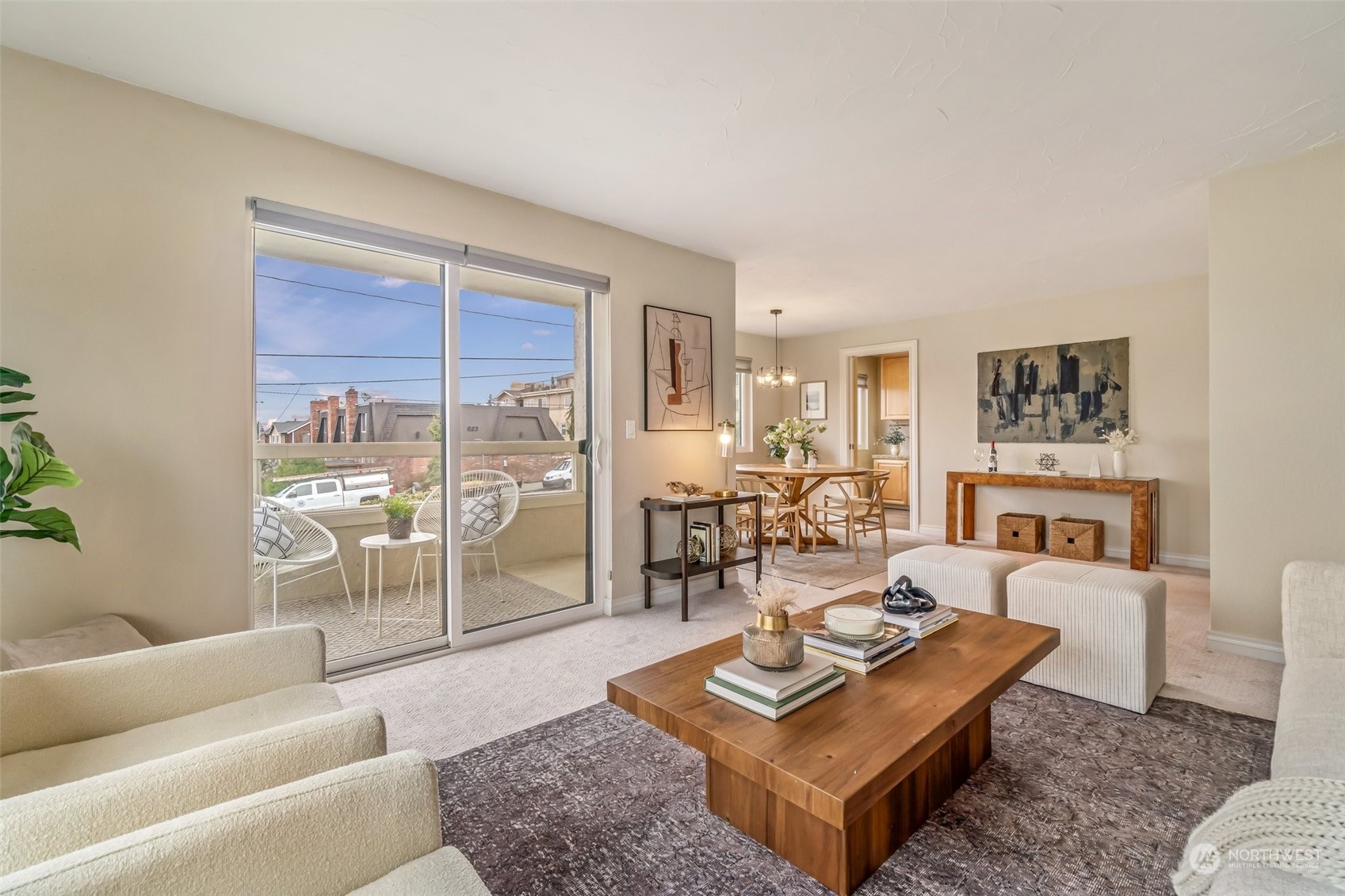 626 Main Street, Unit 4 Edmonds, WA 98020 - Photo 10 of 30 a living room with furniture a rug and a floor to ceiling window