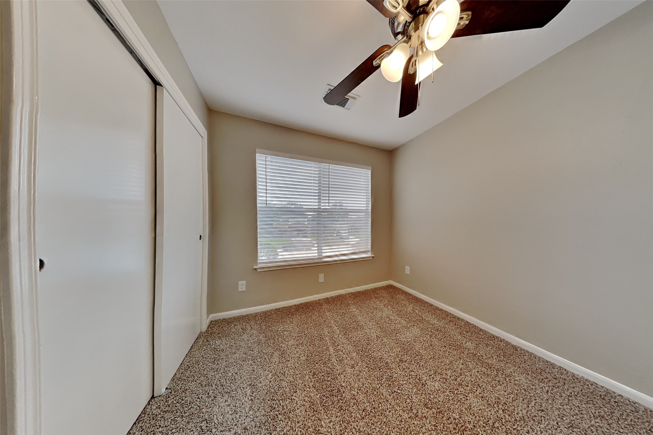 11802 Rolling Stream Drive Tomball, TX 77375 - Photo 11 of 19 a view of an empty room with window and chandelier fan