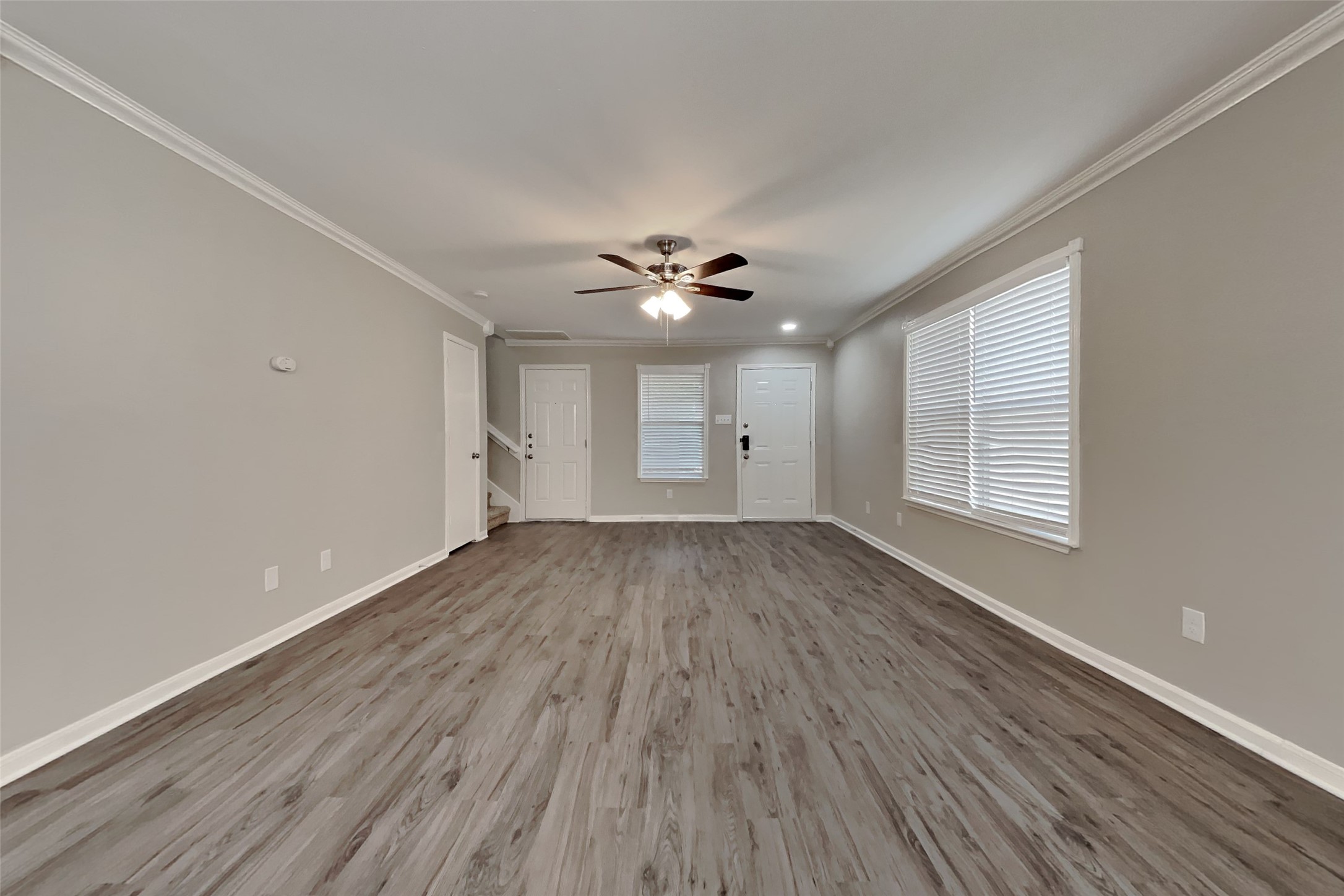 11802 Rolling Stream Drive Tomball, TX 77375 - Photo 3 of 19 a view of an empty room with a window and wooden floor