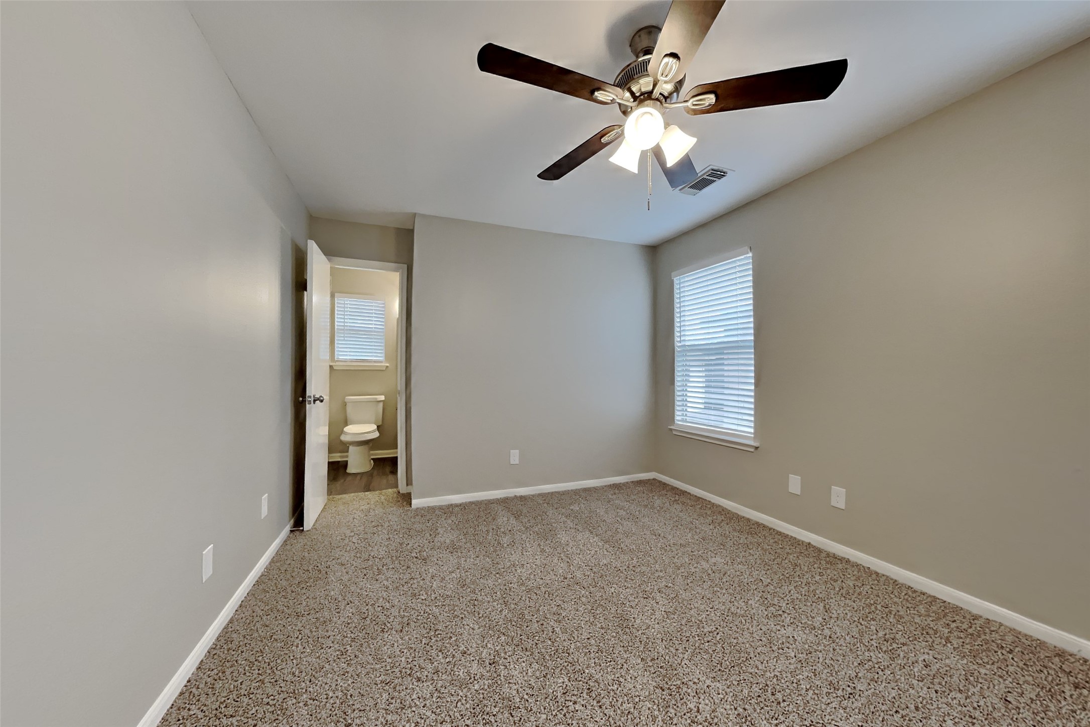 11802 Rolling Stream Drive Tomball, TX 77375 - Photo 9 of 19 an empty room with windows and fan