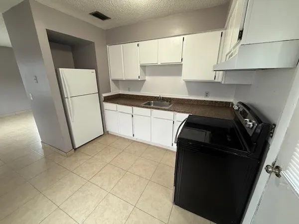 a kitchen with a sink and a stove top oven