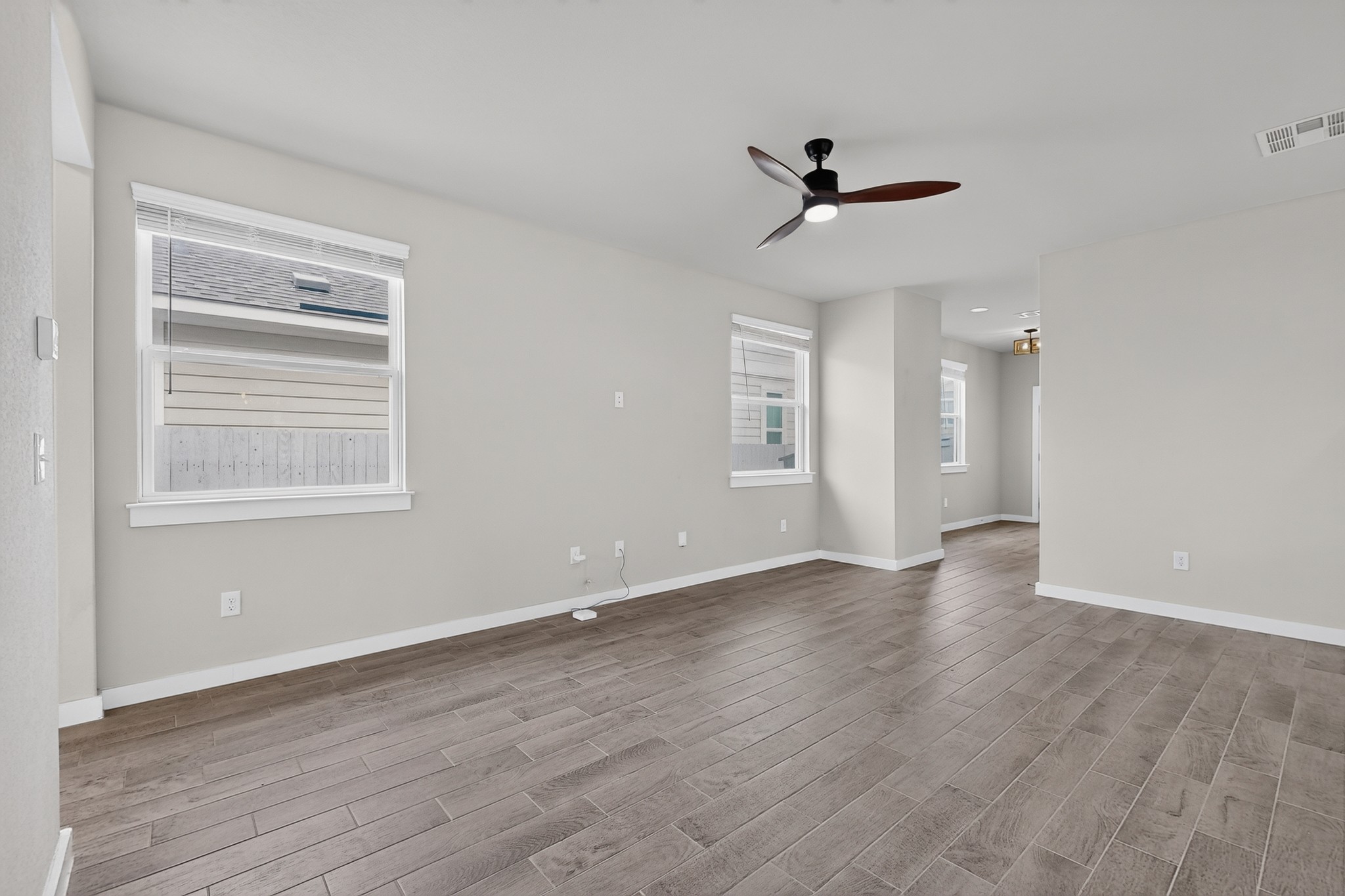 116 Appleberry Lane Elgin, TX 78621 - Photo 6 of 35 A versatile living area features sleek tile flooring and ample natural light, ready for personalization.