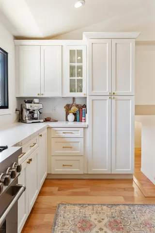 a kitchen with granite countertop cabinets and appliances