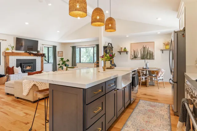 a kitchen with stainless steel appliances granite countertop a sink and cabinets