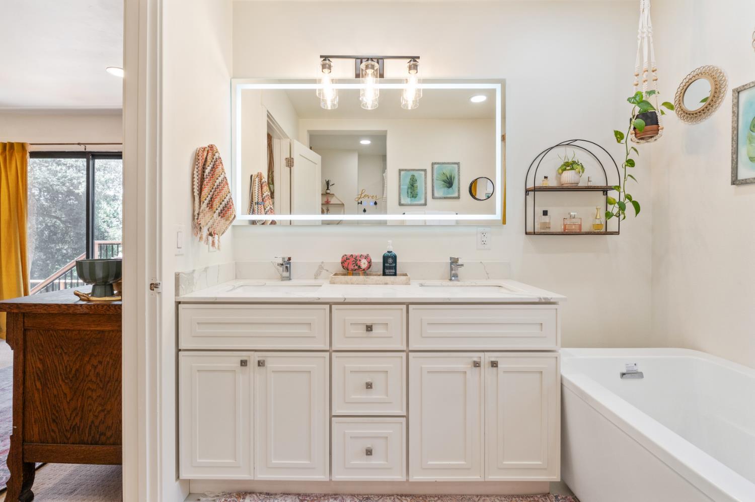 1228 Wingdam Road Murphys, CA 95247 - Photo 19 of 43 a bathroom with a sink a mirror a vanity and bathtub