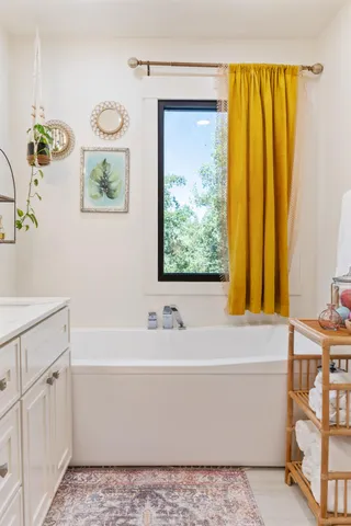 a bathroom with a bathtub a shower and a sink