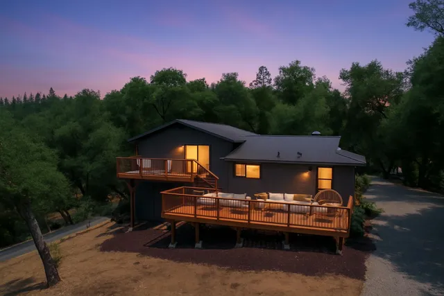 a front view of a house with a yard street from a seating space