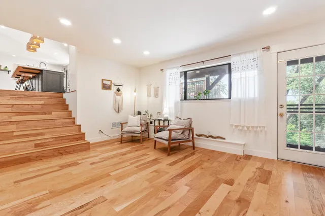 a bedroom with furniture and a wooden floor