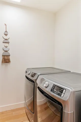 a balcony with wooden floor and outdoor seating