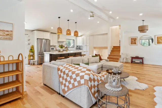 a living room with fireplace furniture and a wooden floor