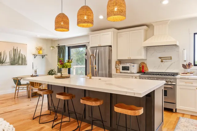 a kitchen with a table chairs and a refrigerator