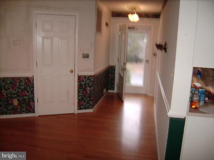 6024 Towles Mill Road Partlow, VA 22534 - Photo 5 of 11 a view of a hallway with wooden floor and staircase
