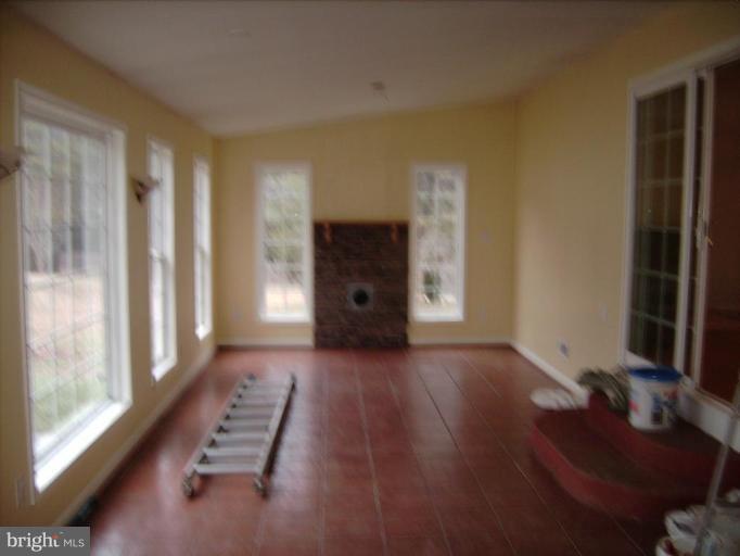 6024 Towles Mill Road Partlow, VA 22534 - Photo 7 of 11 a view of a livingroom with wooden floor and a fireplace