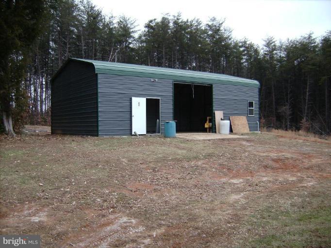 6024 Towles Mill Road Partlow, VA 22534 - Photo 10 of 11 a view of a wooden house with a yard