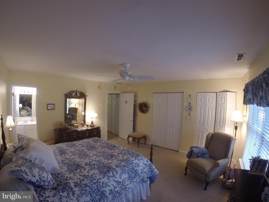 18 Falcon Bridge Road Ocean Pines, MD 21811 - Photo 11 of 21 a spacious bedroom with a bed and furniture