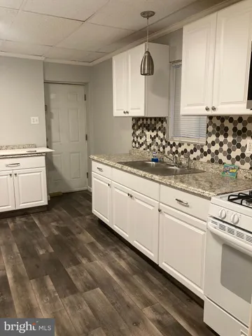 a kitchen with sink cabinets and window