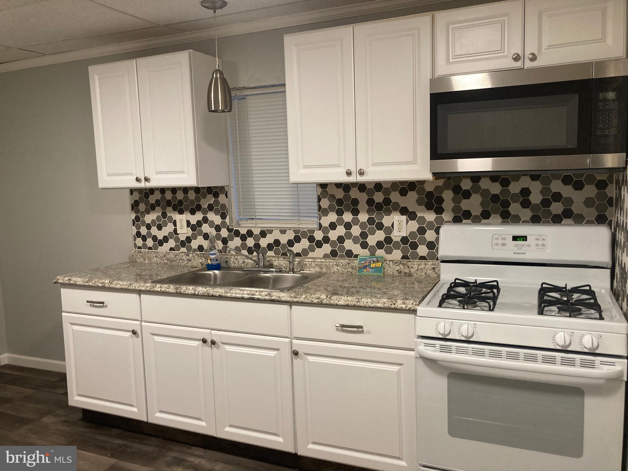 3449 B Street Philadelphia, PA 19134 - Photo 7 of 17 a kitchen with white cabinets and appliances