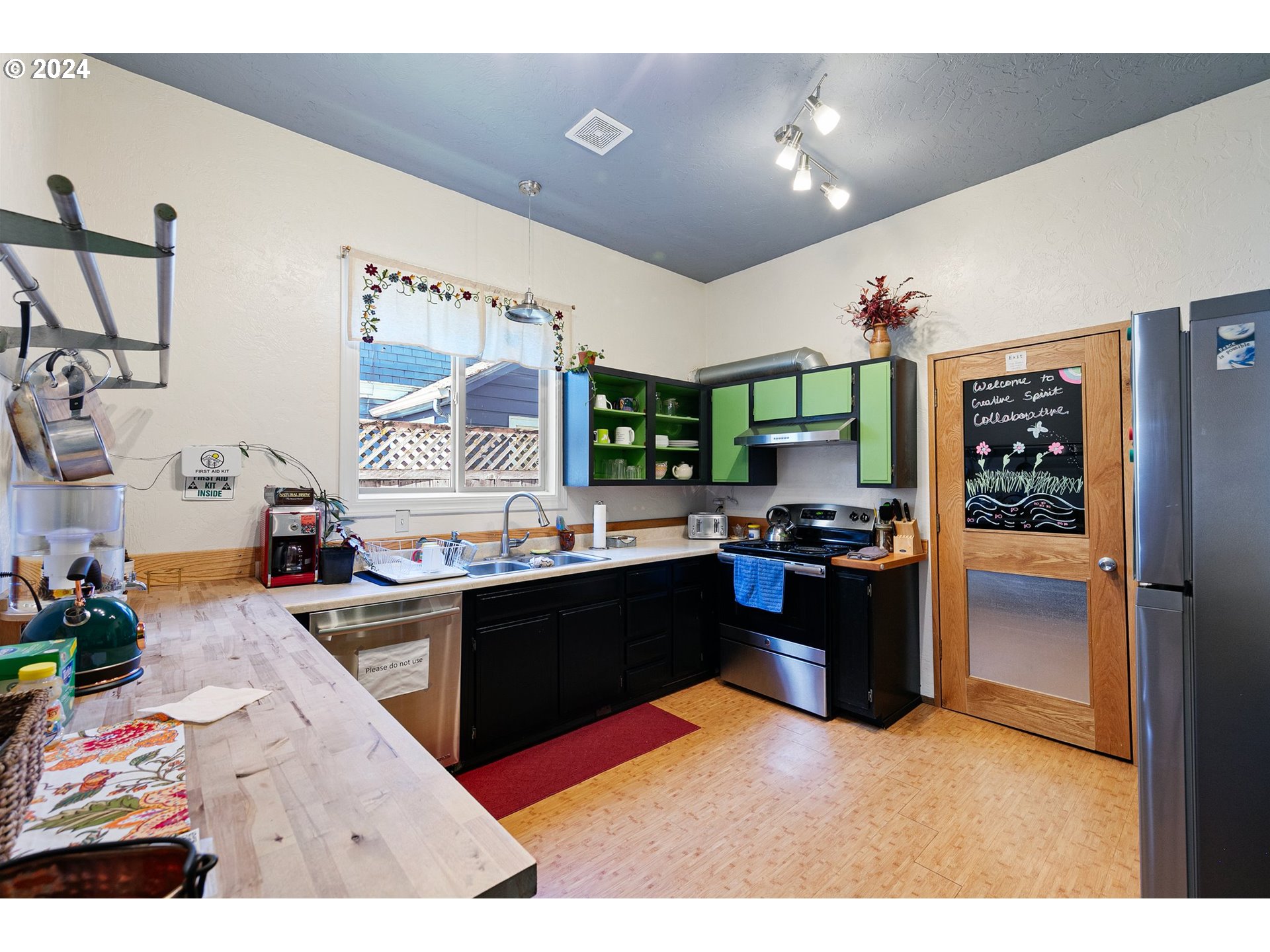 739 West 5th Avenue Eugene, OR 97402 - Photo 8 of 31 a kitchen with stainless steel appliances kitchen island granite countertop a refrigerator and stove