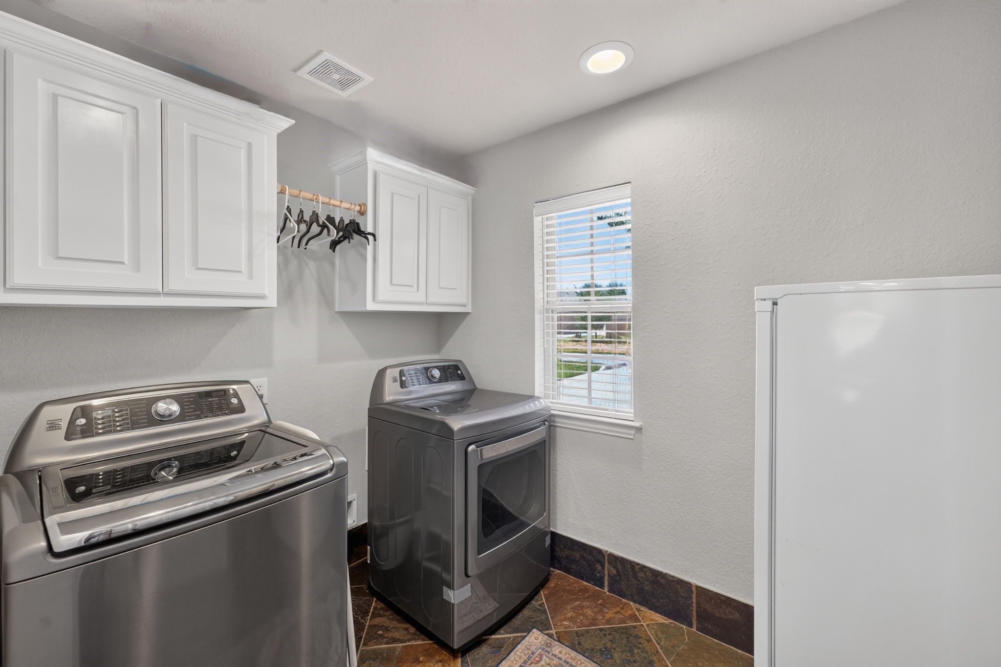 514 Oak Ridge Grove Circle Spring, TX 77386 - Photo 29 of 35 Spacious laundry room with upper cabinetry, extensive workspace and a window providing natural light.