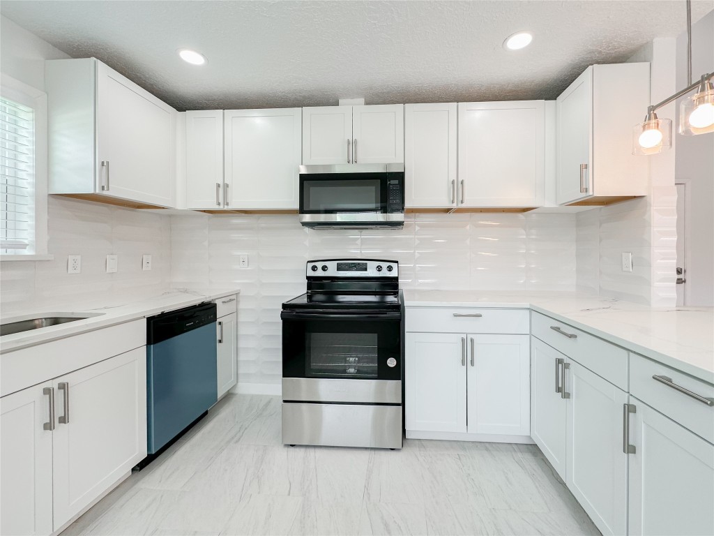 22103 Diane Drive Spring, TX 77373 - Photo 11 of 23 a kitchen with white cabinets and appliances