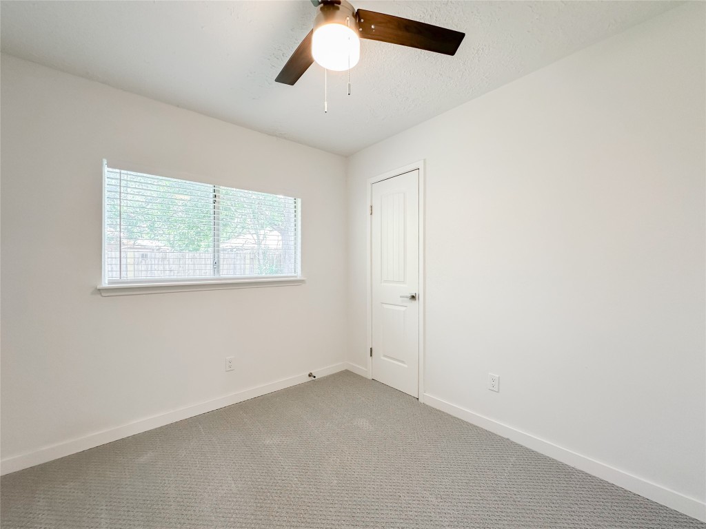 22103 Diane Drive Spring, TX 77373 - Photo 17 of 23 an empty room with a window and a fan