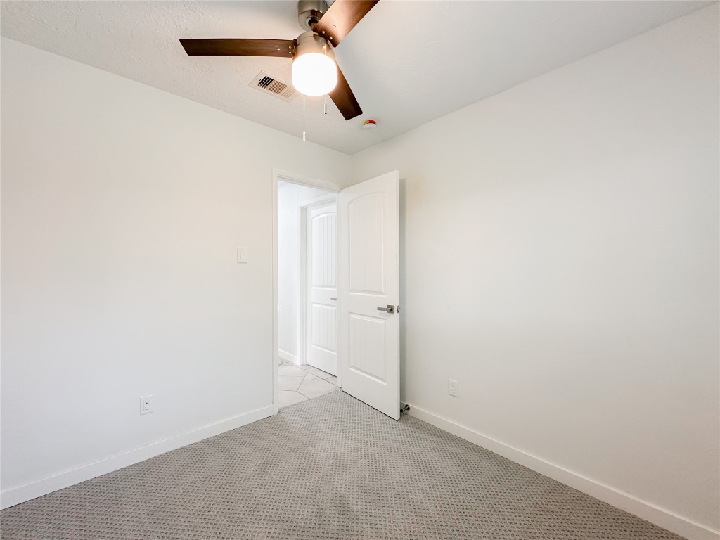 22103 Diane Drive Spring, TX 77373 - Photo 18 of 23 an empty room with a ceiling fan and carpet