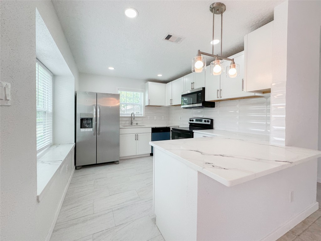 22103 Diane Drive Spring, TX 77373 - Photo 8 of 23 a kitchen with stainless steel appliances a refrigerator sink and microwave