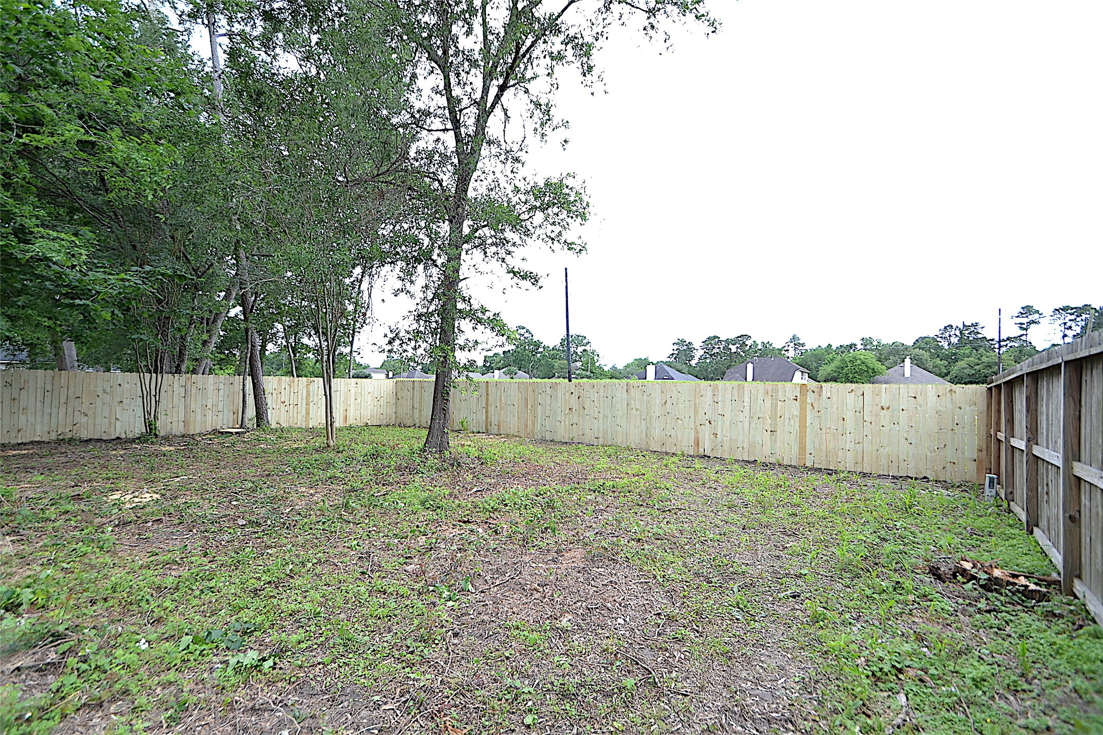 631 Aweigh Drive Crosby, TX 77532 - Photo 15 of 15 a view of a yard with wooden fence and a large tree